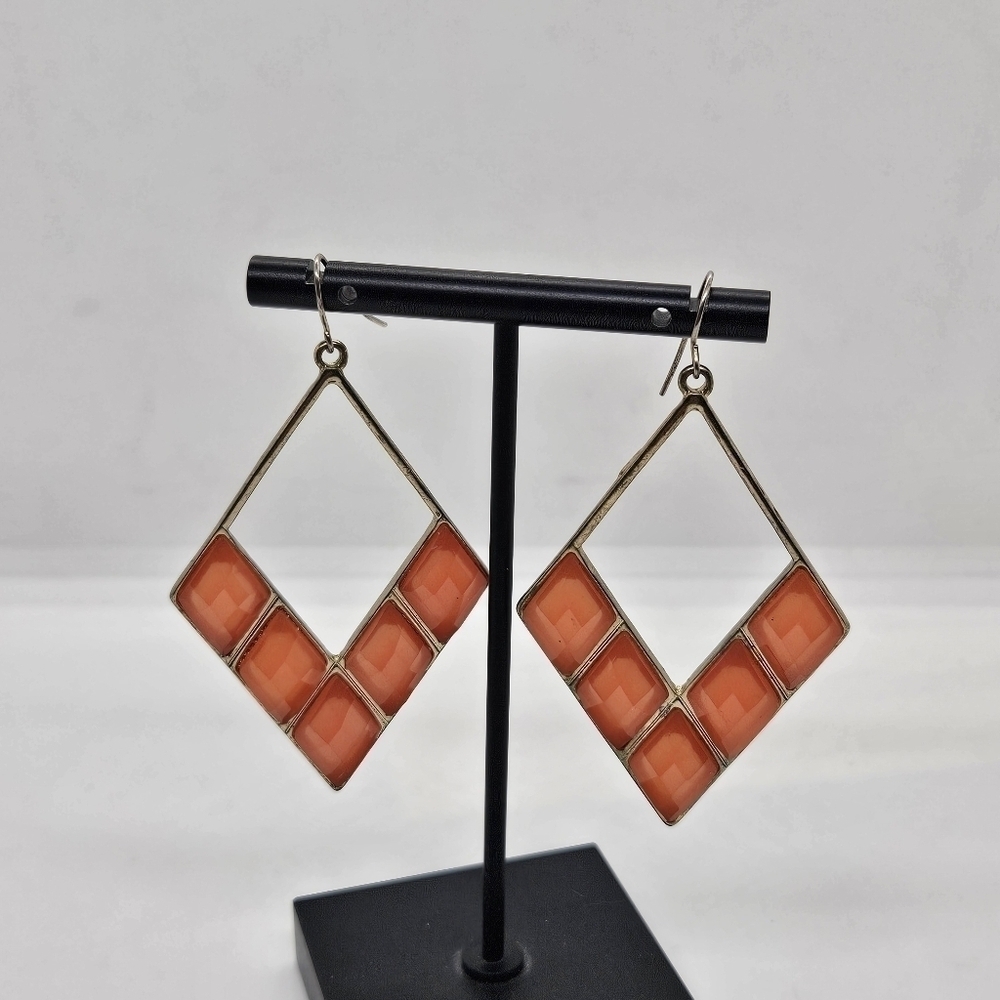 gold tone and light orange diamond shaped dangle earrings